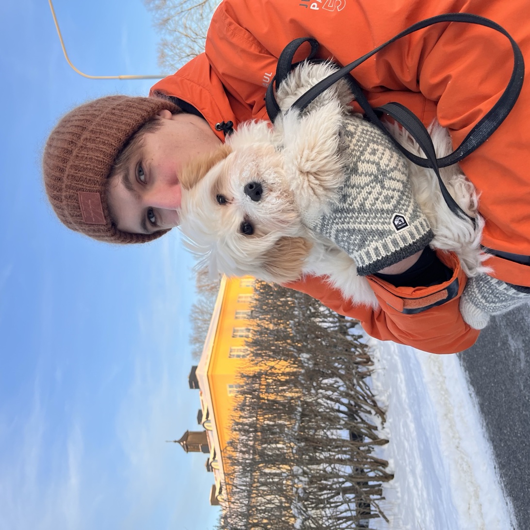 Me holding my dog on a snowy street